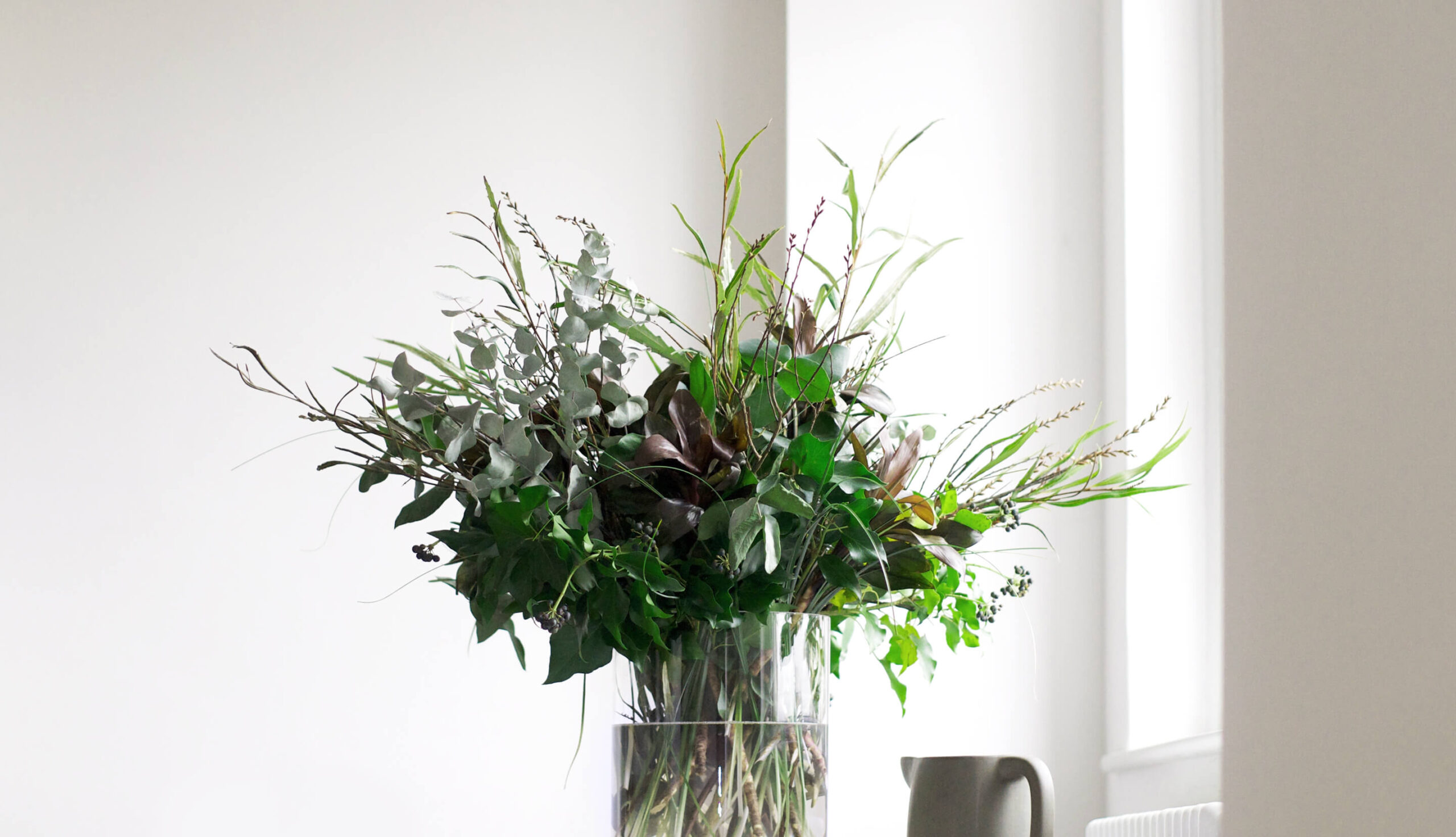 Close-up of a bunch of greenery arranged in a vase