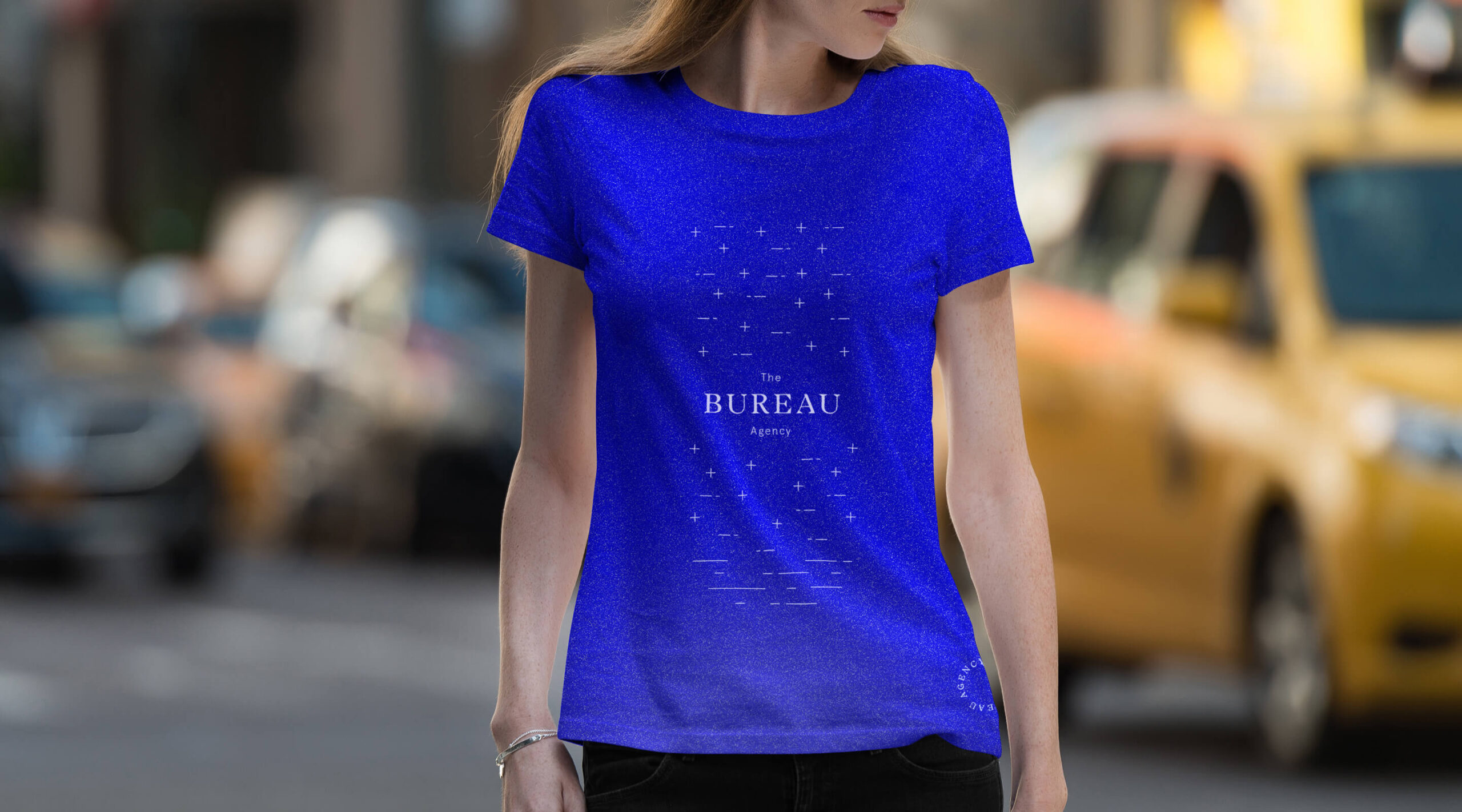 Girl wearing a branded bright blue t-shirt and walking in the streets of New York