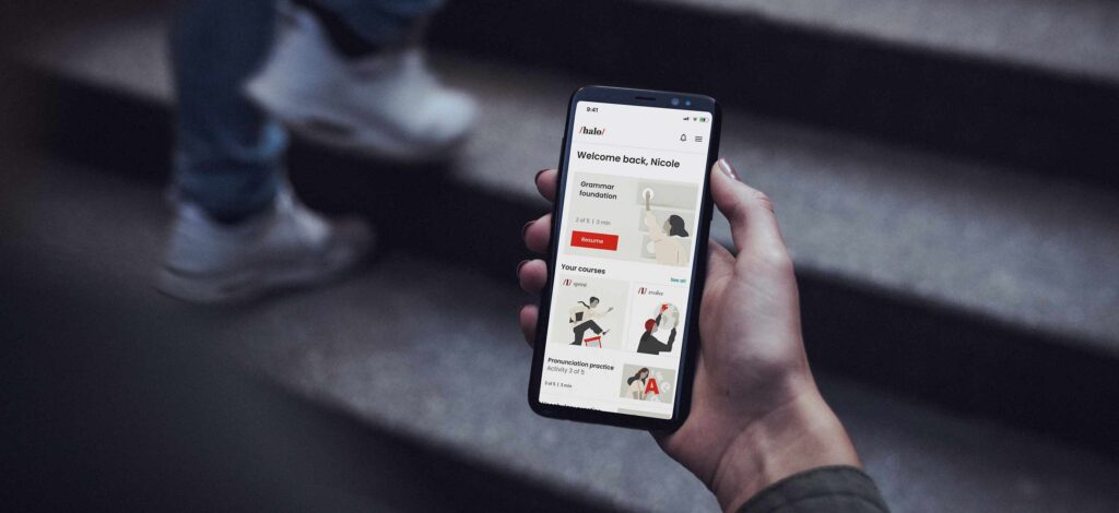 An app UI screen shown an a phone held by a person's hand
